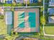 Aerial view showcasing community tennis courts, a sand volleyball court, and meticulously maintained landscaping at 13293 Pontoon Rd, Winter Garden, FL 34787