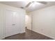 This bedroom features a ceiling fan, wood floors, and a double-door closet for ample storage space at 1356 Scarlet Oak Loop, Winter Garden, FL 34787