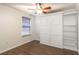 Bedroom with murphy bed, shelving, ceiling fan and window with privacy blinds at 1356 Scarlet Oak Loop, Winter Garden, FL 34787
