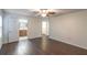 This spacious bedroom features wood-look flooring, a ceiling fan, and bright, natural light from a large window at 1356 Scarlet Oak Loop, Winter Garden, FL 34787
