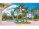 Beautiful community pool surrounded by lush landscaping and towering palm trees at 1356 Scarlet Oak Loop, Winter Garden, FL 34787