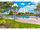Relax in the community pool with ample seating and meticulously maintained landscaping at 1356 Scarlet Oak Loop, Winter Garden, FL 34787
