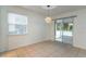 Dining area offers tile floors, a modern light fixture, and sliding glass doors to the patio at 1356 Scarlet Oak Loop, Winter Garden, FL 34787