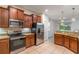 Spacious kitchen with stainless steel appliances, granite countertops, and rich wood cabinetry at 1356 Scarlet Oak Loop, Winter Garden, FL 34787