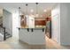 Bright kitchen boasts stainless steel appliances, wood cabinetry, and granite countertops with pendant lighting at 1356 Scarlet Oak Loop, Winter Garden, FL 34787