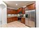 Modern kitchen with granite counters, stainless appliances and rich wood cabinetry at 1356 Scarlet Oak Loop, Winter Garden, FL 34787