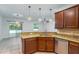 Stylish kitchen featuring granite countertops, stainless steel appliances, and pendant lighting at 1356 Scarlet Oak Loop, Winter Garden, FL 34787