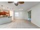 Open-concept living room features tile floors, a ceiling fan, and sliding glass doors to the outdoor patio at 1356 Scarlet Oak Loop, Winter Garden, FL 34787