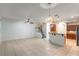 Open living area features tile flooring, high ceilings, and easy access to the staircase and kitchen at 1356 Scarlet Oak Loop, Winter Garden, FL 34787