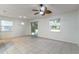 Bright living room features tile floors, two large windows, and sliding glass doors to the outdoor patio at 1356 Scarlet Oak Loop, Winter Garden, FL 34787