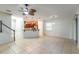 Spacious living area with tile flooring, a staircase, and an open layout connecting to the kitchen at 1356 Scarlet Oak Loop, Winter Garden, FL 34787
