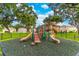 Community playground with multiple slides and climbing features, set on a rubber surface for safety at 1356 Scarlet Oak Loop, Winter Garden, FL 34787