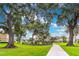 Beautiful green community with walking path leading to a playground and townhomes in the background at 1356 Scarlet Oak Loop, Winter Garden, FL 34787