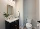 Powder room features a modern black vanity with a marble countertop and gold fixtures at 13617 Haulover Beach Ln, Orlando, FL 32827