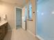 Bright bathroom featuring double vanity, large-format tiling, and an open walk-in shower with white tile surround at 13617 Haulover Beach Ln, Orlando, FL 32827