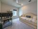 Cozy bedroom features a daybed, neutral decor, and a functional desk area with dual monitors at 13617 Haulover Beach Ln, Orlando, FL 32827