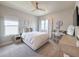 Neutral bedroom offers a comfortable bed, bright windows, and a charming desk area with decor accents at 13617 Haulover Beach Ln, Orlando, FL 32827