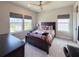Bedroom with large windows, hardwood floors, neutral paint and a basketball hoop at 13617 Haulover Beach Ln, Orlando, FL 32827