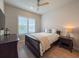 Bedroom with neutral walls, a dark wood bed frame and view to exterior at 13617 Haulover Beach Ln, Orlando, FL 32827