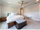 Bright bedroom offers a bed with white bedding, a wooden chest, and neutral walls with clean lines at 13617 Haulover Beach Ln, Orlando, FL 32827