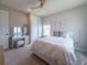 Bedroom featuring a bed with decorative pillows, vanity desk, and bright windows with natural light at 13617 Haulover Beach Ln, Orlando, FL 32827