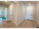 Hallway with hardwood floors leading to an exterior door and bonus room at 13617 Haulover Beach Ln, Orlando, FL 32827