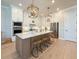 Well-lit kitchen with stainless steel appliances, a central island with barstool seating, and ample counter space at 13617 Haulover Beach Ln, Orlando, FL 32827
