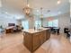 Open-concept kitchen with a spacious island, modern appliances, and seamless flow to the living and dining areas at 13617 Haulover Beach Ln, Orlando, FL 32827