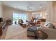 Bright and airy living room with a view of the pool, comfortable furnishings, and an open-concept design at 13617 Haulover Beach Ln, Orlando, FL 32827