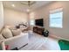 Bright living room featuring a ceiling fan, lots of natural light and comfortable seating at 13617 Haulover Beach Ln, Orlando, FL 32827
