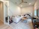 Bright living room with white carpet, comfortable couch and view to exterior at 13617 Haulover Beach Ln, Orlando, FL 32827