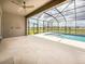 Screened-in lanai with a large pool, view of the water, and spacious outdoor entertaining area with tile floors at 13617 Haulover Beach Ln, Orlando, FL 32827