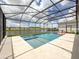 Beautiful pool with a -safe ledge, lake view, and a large screened-in patio for outdoor relaxation at 13617 Haulover Beach Ln, Orlando, FL 32827
