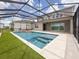 Backyard pool featuring screened enclosure, outdoor living space, and manicured green lawn for added backyard appeal at 13617 Haulover Beach Ln, Orlando, FL 32827