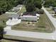 Aerial shot of property featuring detached garage, screened-in pool, and spacious fenced yard at 13785 Se 39Th Ter, Summerfield, FL 34491