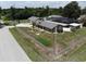 Aerial view capturing the home, detached garage, enclosed pool, and lush landscaping at 13785 Se 39Th Ter, Summerfield, FL 34491