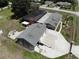 Aerial view showing the home, large detached garage, enclosed pool, and fenced yard at 13785 Se 39Th Ter, Summerfield, FL 34491