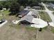 Aerial view showcasing the home, large detached garage, pool, and ample yard space at 13785 Se 39Th Ter, Summerfield, FL 34491