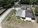 Overhead view of the property featuring a detached garage, pool enclosure, and spacious yard at 13785 Se 39Th Ter, Summerfield, FL 34491