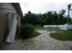 Backyard featuring outdoor shower, stone patio, and stone fire pit with seating at 13785 Se 39Th Ter, Summerfield, FL 34491