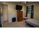 Well-lit bedroom featuring a comfortable bed, flat screen TV, window, and easy access door at 13785 Se 39Th Ter, Summerfield, FL 34491