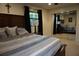 Comfortable bedroom featuring a comfortable bed, bedside lamps, mirrored closet, and natural light at 13785 Se 39Th Ter, Summerfield, FL 34491