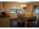 Cozy dining room with a farmhouse table, wooden chairs, and natural light at 13785 Se 39Th Ter, Summerfield, FL 34491