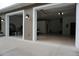 Spacious two-car garage with automatic doors and ample parking space, featuring an inside lighting system at 13785 Se 39Th Ter, Summerfield, FL 34491