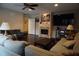Bright living room with a ceiling fan, fireplace, mounted television, and comfortable sofas at 13785 Se 39Th Ter, Summerfield, FL 34491