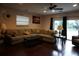 Comfortable living room with a sectional sofa, dark hardwood flooring, and natural light at 13785 Se 39Th Ter, Summerfield, FL 34491