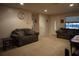 Cozy living room with neutral carpet, dual couches, and a view of the front door at 13785 Se 39Th Ter, Summerfield, FL 34491