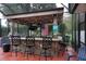 Inviting outdoor bar area with TV, fun decor, and seating for entertaining at 13785 Se 39Th Ter, Summerfield, FL 34491