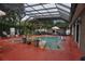 This is the pool area showcasing a spacious enclosed lanai, and comfortable seating at 13785 Se 39Th Ter, Summerfield, FL 34491