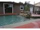 Backyard pool featuring decorative waterfall and outdoor shower at 13785 Se 39Th Ter, Summerfield, FL 34491